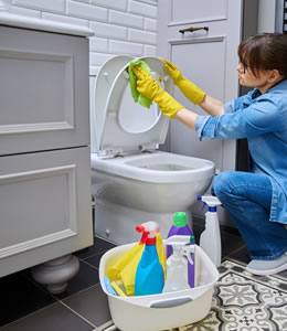 woman cleaning toilet