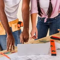 two people reviewing building plans