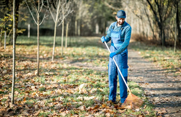 man raking leaves